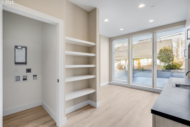 interior space featuring hookup for a washing machine, laundry area, light wood-style flooring, and electric dryer hookup