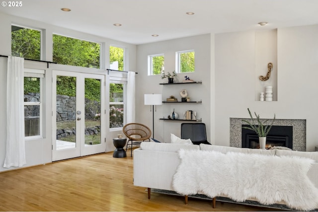 1369 SW Broadway Dr, Portland, OR 97201 - living room with a glass covered fireplace, light wood-type flooring, french doors, and recessed lighting