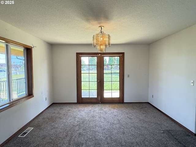 16117 NE 87th St, Vancouver, WA 98682 - carpeted empty room with a chandelier, baseboards, a textured ceiling, and french doors