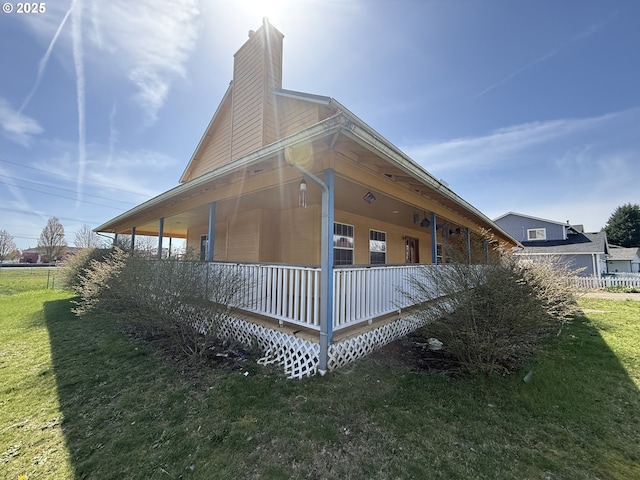 16117 NE 87th St, Vancouver, WA 98682 - view of property exterior featuring a chimney, a yard, and covered porch