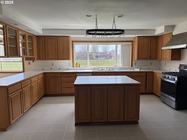 16117 NE 87th St, Vancouver, WA 98682 - kitchen featuring stainless steel range with gas stovetop, light countertops, a kitchen island, glass insert cabinets, and recessed lighting