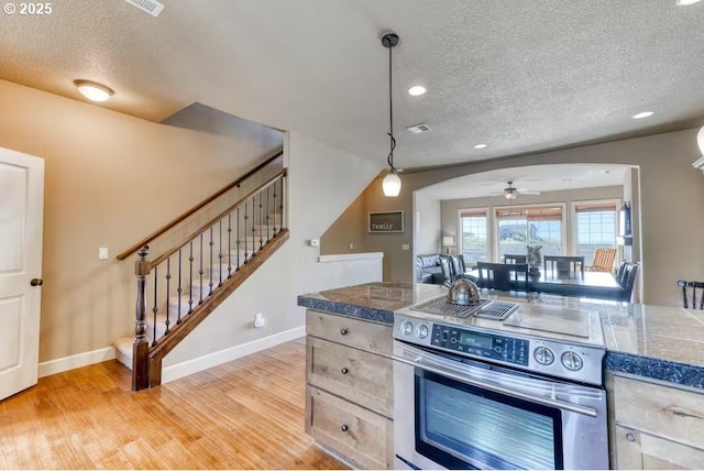547 Front St, Rockaway Beach, OR 97136 - kitchen featuring electric range, ceiling fan, light hardwood / wood-style flooring, pendant lighting, and a textured ceiling