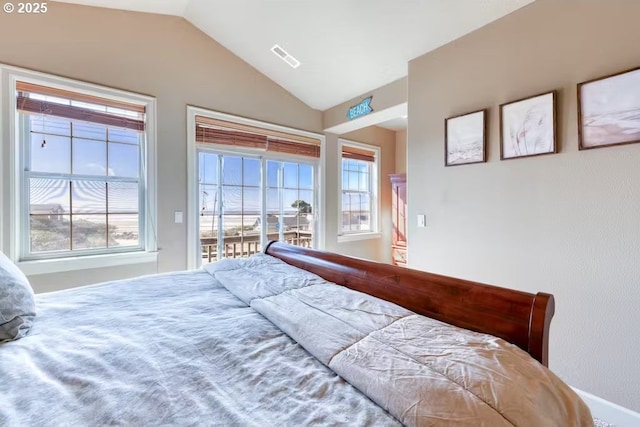 547 Front St, Rockaway Beach, OR 97136 - bedroom featuring multiple windows and lofted ceiling