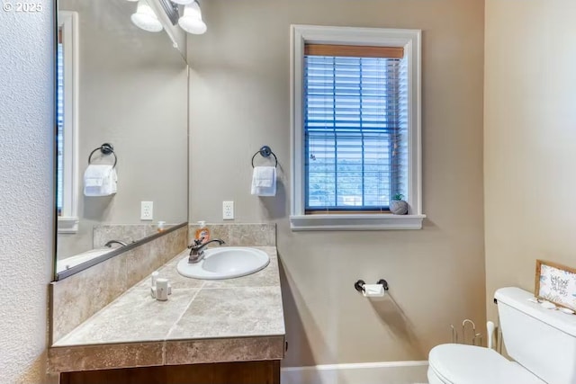 547 Front St, Rockaway Beach, OR 97136 - bathroom featuring vanity, toilet, and a wealth of natural light
