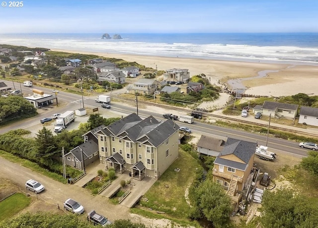 drone / aerial view featuring a water view and a view of the beach