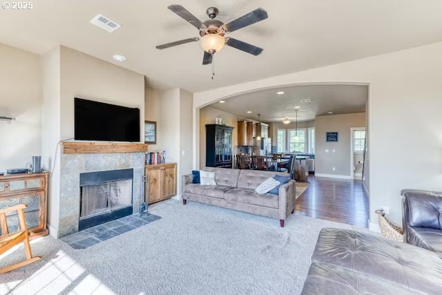 547 Front St, Rockaway Beach, OR 97136 - carpeted living room with ceiling fan and a tile fireplace