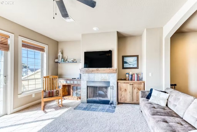 547 Front St, Rockaway Beach, OR 97136 - living room with a tile fireplace, light colored carpet, and ceiling fan