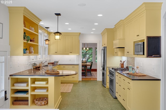 2603 NE 11th Ave, Portland, OR 97212 - kitchen featuring stainless steel appliances, open shelves, cream cabinets, tasteful backsplash, and recessed lighting
