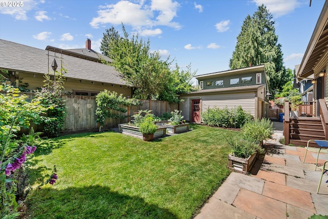 2603 NE 11th Ave, Portland, OR 97212 - fenced yard featuring a garden, an outbuilding, and a patio