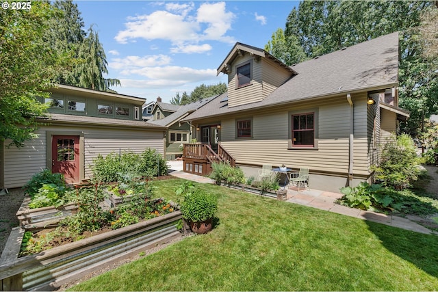 2603 NE 11th Ave, Portland, OR 97212 - rear view of property with a vegetable garden, a lawn, a patio area, and roof with shingles