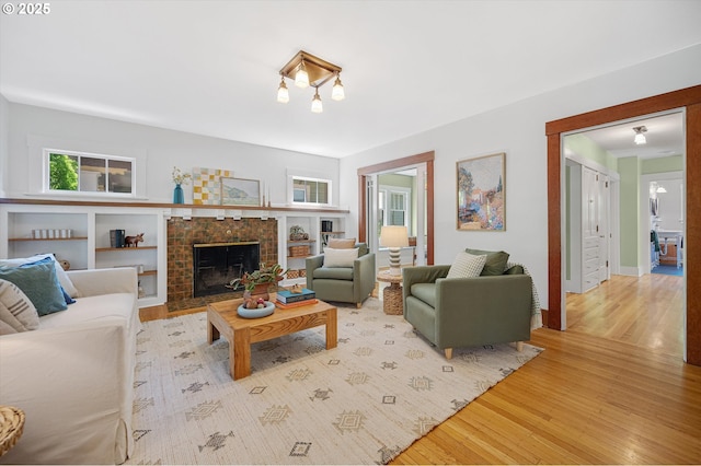 2603 NE 11th Ave, Portland, OR 97212 - living room featuring wood finished floors and a fireplace with flush hearth