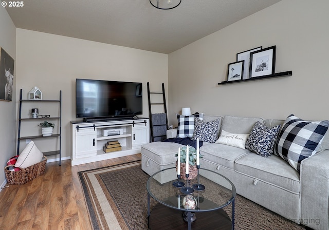 living area featuring baseboards and wood finished floors