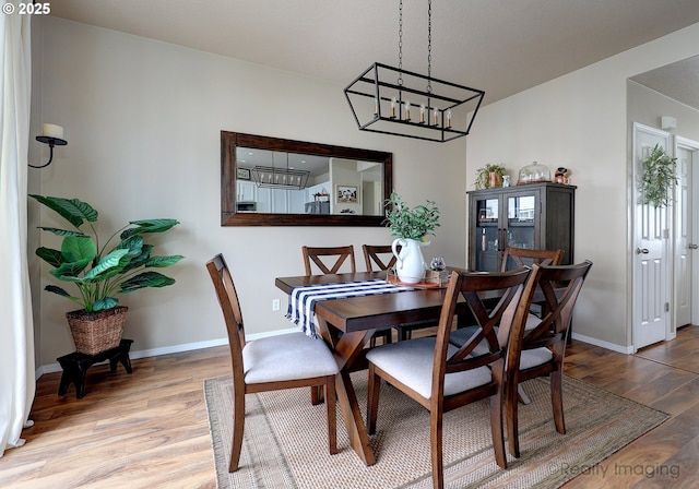 dining area with wood finished floors and baseboards