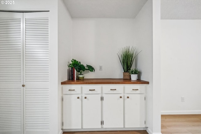 interior space featuring baseboards and wood finished floors