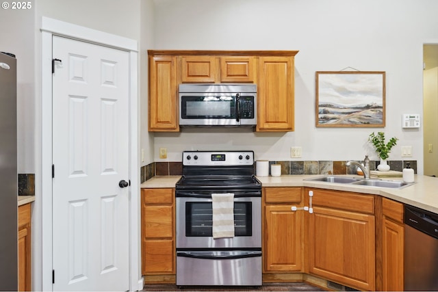 1230 W Fairview Dr, Springfield, OR 97477 - kitchen with stainless steel appliances, light countertops, and brown cabinetry
