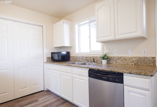 kitchen featuring a sink, stainless steel dishwasher, white cabinetry, black microwave, and light wood finished floors