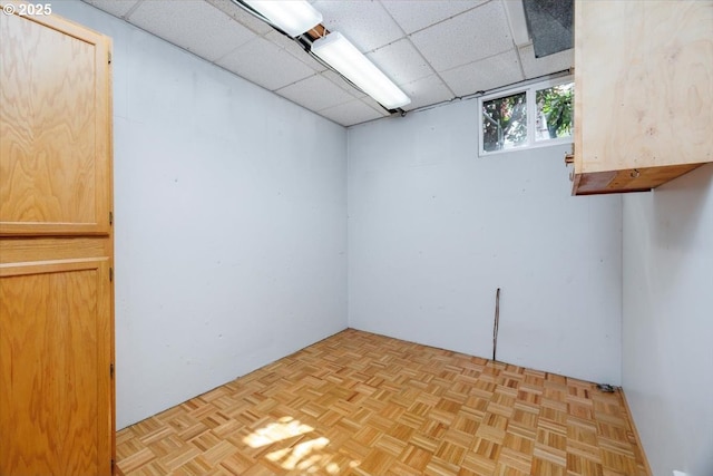 basement featuring a paneled ceiling