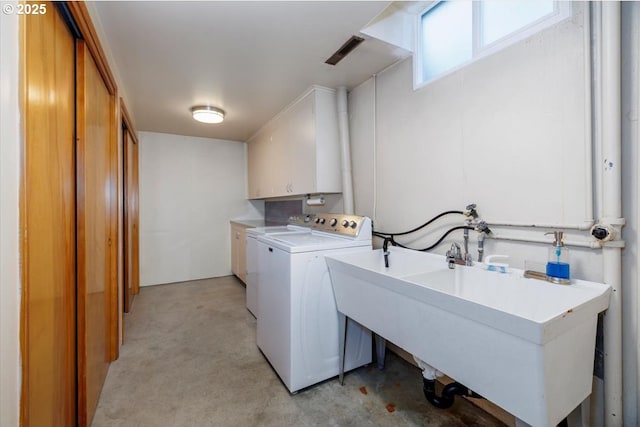 laundry room with a sink, separate washer and dryer, light carpet, and cabinet space