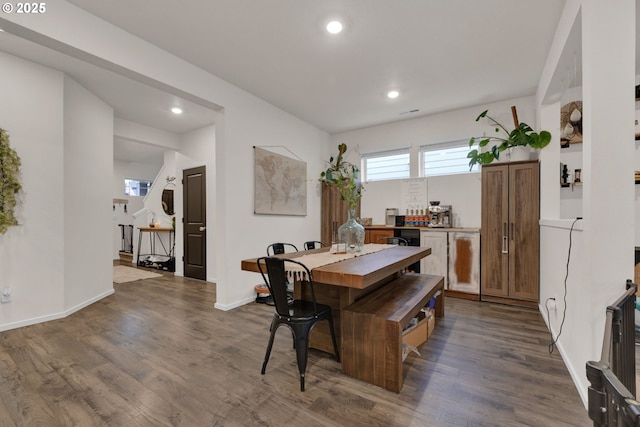 dining room with baseboards, dark wood finished floors, and recessed lighting