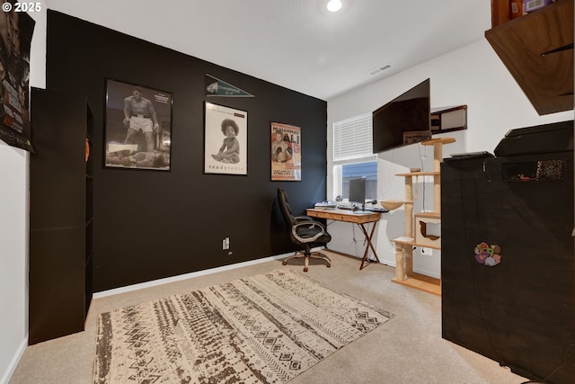 office space with light colored carpet, visible vents, and baseboards