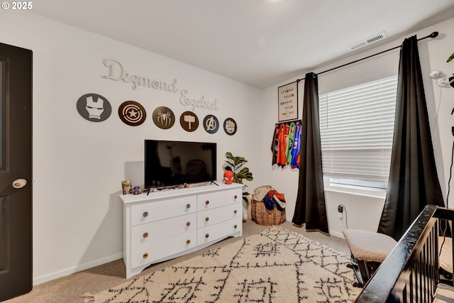 bedroom with light carpet, multiple windows, visible vents, and baseboards