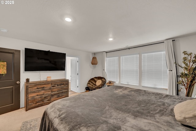 bedroom featuring light carpet and recessed lighting