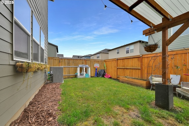 view of yard featuring central air condition unit and a fenced backyard