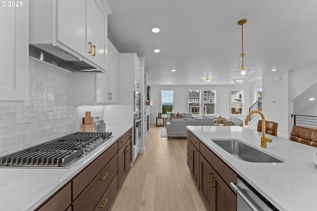 2134 Eleanor Rd, West Linn, OR 97068 - kitchen with open floor plan, a sink, stainless steel appliances, light wood-type flooring, and white cabinetry