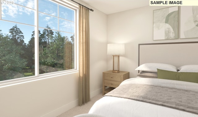 carpeted bedroom featuring multiple windows