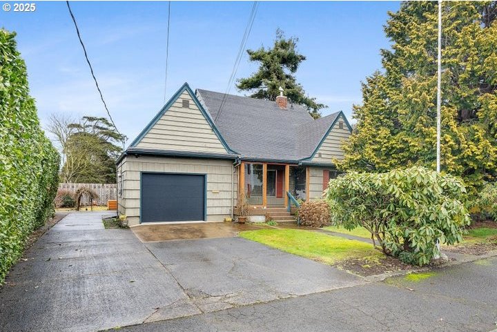 view of front of home with an attached garage, fence, and driveway