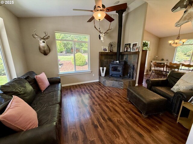 94703 Johnson Rd, Marcola, OR 97454 - living area featuring vaulted ceiling, wood finished floors, ceiling fan, a wood stove, and a chandelier