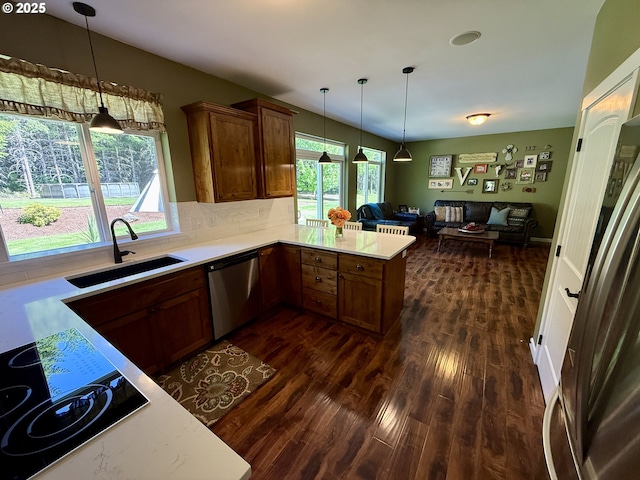 94703 Johnson Rd, Marcola, OR 97454 - kitchen featuring dishwasher, open floor plan, light countertops, a peninsula, and dark wood-style flooring