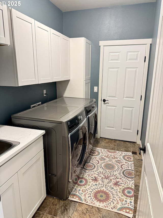 94703 Johnson Rd, Marcola, OR 97454 - laundry area featuring cabinet space, separate washer and dryer, and dark stone finish flooring