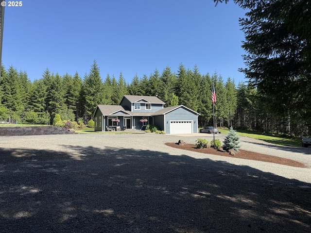 94703 Johnson Rd, Marcola, OR 97454 - view of front facade with a garage, driveway, and a forest view