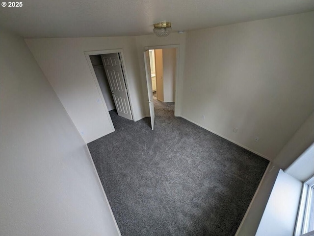 empty room featuring dark carpet