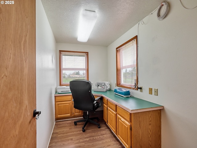 1301 49th Ave, Salem, OR 97317 - office space featuring a textured ceiling, light wood-style flooring, healthy amount of natural light, and built in desk