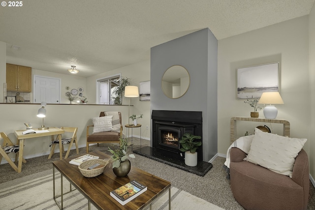 living room featuring carpet flooring, a textured ceiling, and baseboards