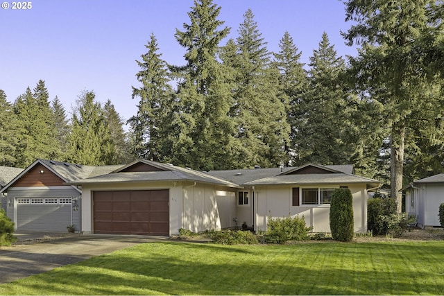 ranch-style house with an attached garage, concrete driveway, and a front yard