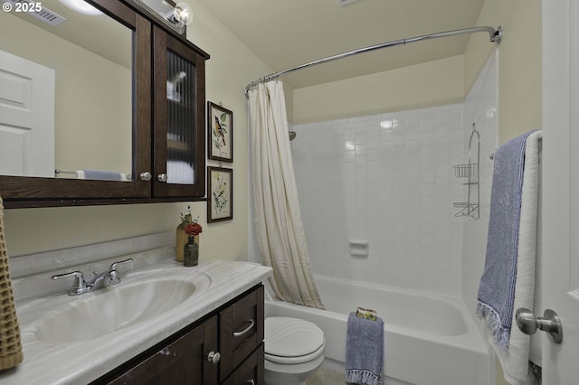 bathroom featuring visible vents, vanity, toilet, and shower / tub combo with curtain