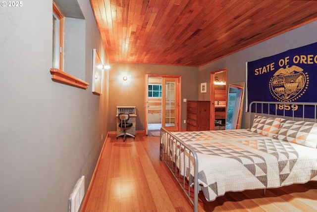 bedroom with wood ceiling and hardwood / wood-style flooring