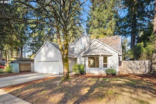 view of front of home with fence, driveway, and an attached garage