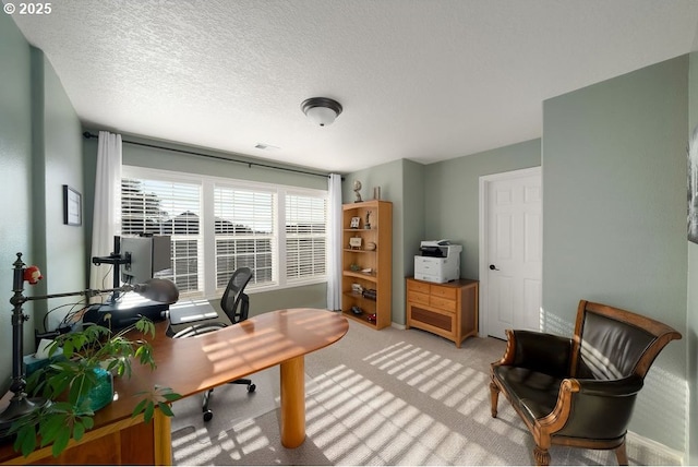 home office with light carpet and a textured ceiling