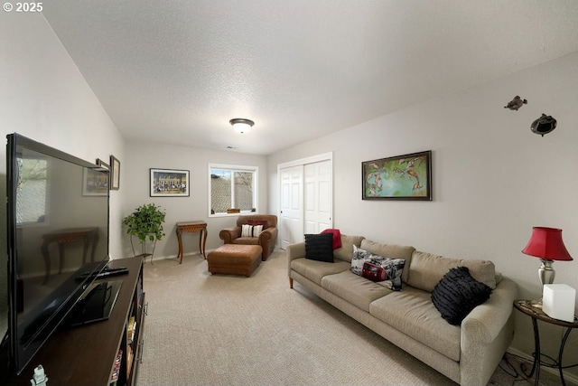 carpeted living area featuring a textured ceiling and baseboards