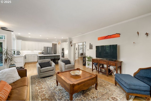 living area featuring ornamental molding, recessed lighting, and light wood finished floors