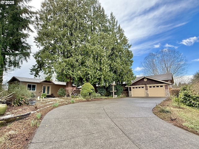 ranch-style house featuring driveway and a garage