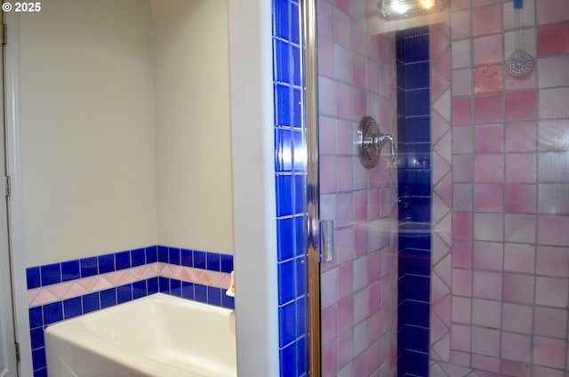 bathroom with a shower stall and a bath