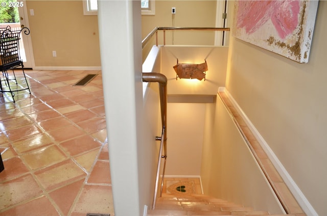 stairs with visible vents and baseboards