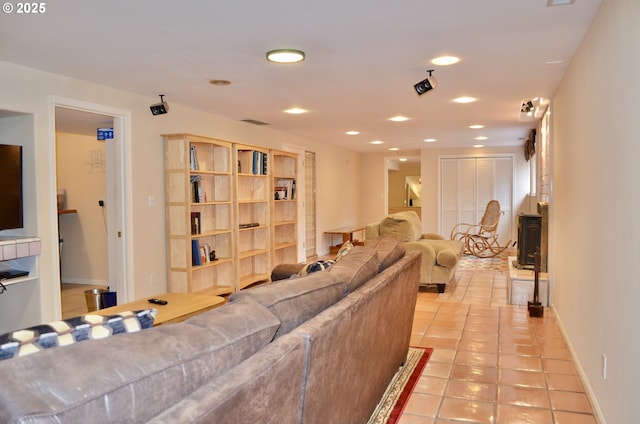 living room with light tile patterned floors, recessed lighting, and baseboards