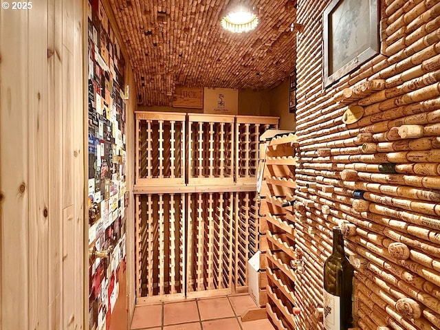 wine cellar with tile patterned floors and log walls