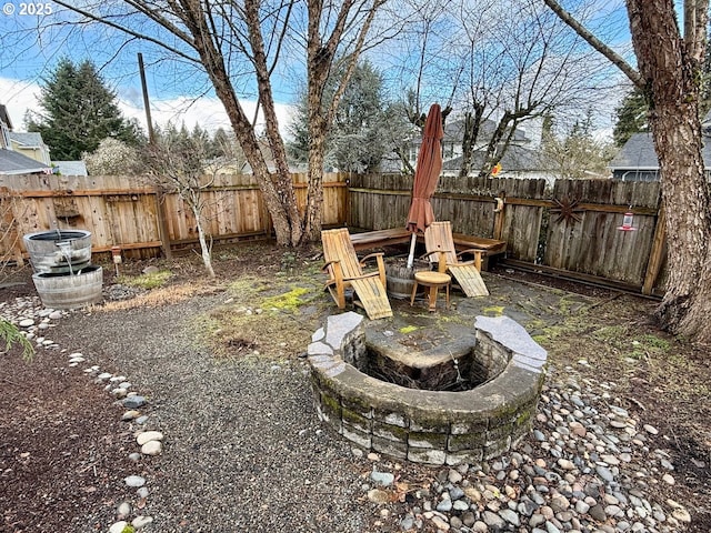 view of yard with an outdoor fire pit and a fenced backyard